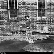 A woman standing barefoot outside Northfield Mental Hospital, South Australia